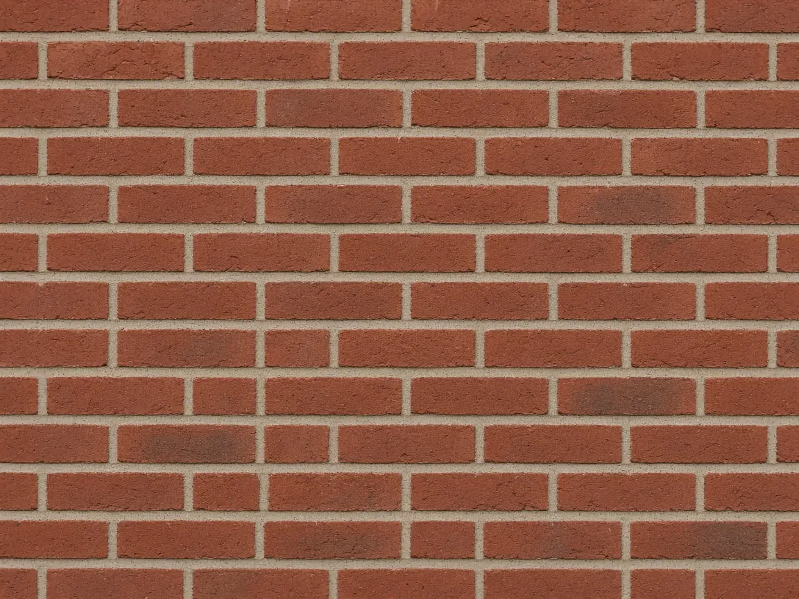 Freshly tuckpointed red brick wall